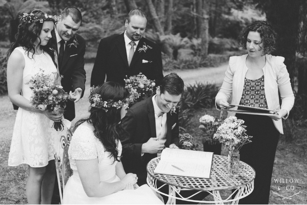 Megan-and-Marc-Blue-Mountains-wedding-signing-the-register-with-celebrant-Andrea-Calodolce