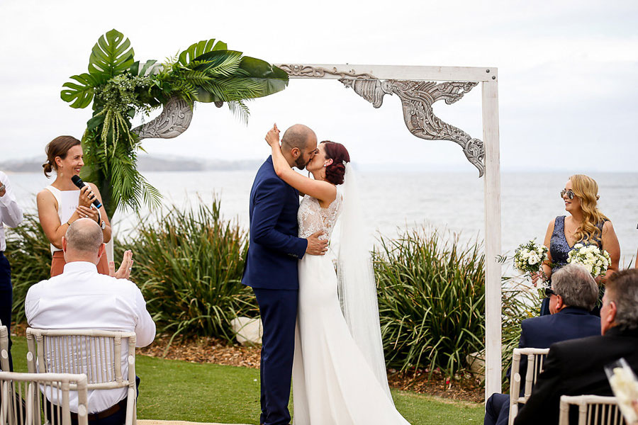 Bride and Groom share their first kiss at beach wedding