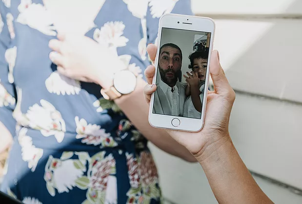 Guests watch wedding from phone