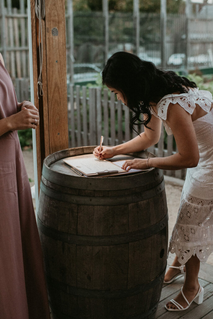 Bride signing marriage certificate