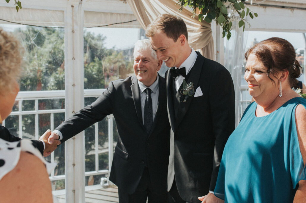 Parents of grooms greet each other at wedding