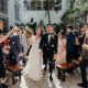 Bride and Groom walking down aisle with guests throwing petals