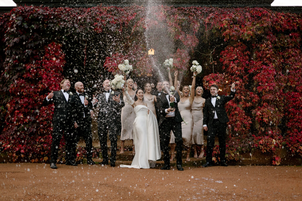 Newlyweds and wedding party doing epic Champagne spray at Bendooley Estate 